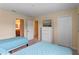 Spacious bedroom with two twin beds, dresser, and access to a bathroom at 1424 Rolling Fairway Dr, Davenport, FL 33896