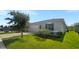 Newly built home with gray siding, two-car garage, and grassy yard at 273 Summershore Dr, Auburndale, FL 33823