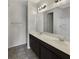 Bathroom with double vanity, dark brown cabinets, and large mirror at 273 Summershore Dr, Auburndale, FL 33823