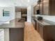 Spacious kitchen featuring granite countertops and dark brown cabinetry at 273 Summershore Dr, Auburndale, FL 33823