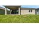 Landscaped backyard with covered patio and grassy area at 273 Summershore Dr, Auburndale, FL 33823
