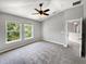 Bright bedroom featuring two large windows and carpet flooring at 10888 Eclipse Lily Way # 62A, Orlando, FL 32832