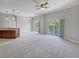 Spacious living room with carpet flooring and access to balcony at 10888 Eclipse Lily Way # 62A, Orlando, FL 32832