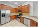 Modern kitchen with stainless steel appliances and wood cabinets at 10888 Eclipse Lily Way # 62A, Orlando, FL 32832