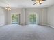 Spacious living room with carpeting and access to a balcony at 10888 Eclipse Lily Way # 62A, Orlando, FL 32832