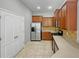 Modern kitchen with stainless steel appliances and wood cabinets at 10888 Eclipse Lily Way # 62A, Orlando, FL 32832