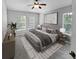 Main bedroom with carpeted floor, large windows, and ceiling fan at 10888 Eclipse Lily Way # 62A, Orlando, FL 32832