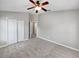 Well-lit bedroom with carpeted floors and ceiling fan at 10888 Eclipse Lily Way # 62A, Orlando, FL 32832