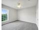 Bright bedroom with ceiling fan and large window at 215 Longview Ave # 305, Kissimmee, FL 34747