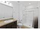 Clean bathroom with shower/tub combo and dark vanity at 1100 James Way, Kissimmee, FL 34759