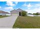 Single-story home with attached garage and well-manicured lawn at 1100 James Way, Kissimmee, FL 34759