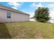Large backyard with a mostly flat grassy area at 1100 James Way, Kissimmee, FL 34759