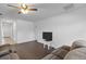 Living room with dark brown sectional sofa and wood-look flooring at 1100 James Way, Kissimmee, FL 34759