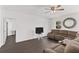 Spacious living room with dark brown sectional sofa and ceiling fan at 1100 James Way, Kissimmee, FL 34759