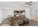 Open living room with sectional sofa, kitchen views, and wood floors at 1100 James Way, Kissimmee, FL 34759