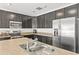 Modern kitchen with dark cabinets, stainless steel appliances, and island at 1100 James Way, Kissimmee, FL 34759