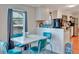 Retro-style dining area with teal chairs and a white table at 1825 Ruby St, Lakeland, FL 33815