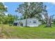 Single wide mobile home with large tree in the backyard at 1825 Ruby St, Lakeland, FL 33815