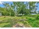 Large grassy backyard with mature trees at 1825 Ruby St, Lakeland, FL 33815