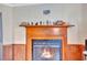 Ornate fireplace with decorative mantle and a warm fire at 1825 Ruby St, Lakeland, FL 33815