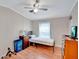 Bedroom with wood floors, ceiling fan, and dresser at 1825 Ruby St, Lakeland, FL 33815