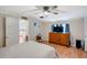 Comfortable bedroom with dresser, ceiling fan, and a view into the kitchen at 1825 Ruby St, Lakeland, FL 33815