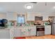Bright kitchen features white cabinets, granite countertops, and stainless steel appliances at 1825 Ruby St, Lakeland, FL 33815