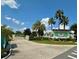 Attractive community entrance with landscaping and solar panels at 1077 Sugar Loaf Key Loop, Lady Lake, FL 32159