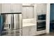 Stainless steel appliances and modern gray cabinets at 1077 Sugar Loaf Key Loop, Lady Lake, FL 32159