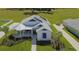 White house with blue accents, solar panels, and landscaped yard at 1077 Sugar Loaf Key Loop, Lady Lake, FL 32159
