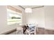 Small dining area with glass-top table, white chairs and window at 1077 Sugar Loaf Key Loop, Lady Lake, FL 32159