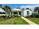 Charming white house with blue shutters at 1077 Sugar Loaf Key Loop, Lady Lake, FL 32159