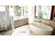 Bathroom with freestanding tub, walk-in shower, and marble flooring at 1077 Sugar Loaf Key Loop, Lady Lake, FL 32159