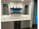 Wet bar with glass-front cabinets, quartz countertop, and wine cooler at 1077 Sugar Loaf Key Loop, Lady Lake, FL 32159