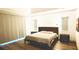 Spacious bedroom with large bed, neutral decor, and window blinds at 1077 Sugar Loaf Key Loop, Lady Lake, FL 32159