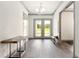 Bright entryway with wood-look flooring, bench, and natural light at 1077 Sugar Loaf Key Loop, Lady Lake, FL 32159