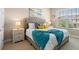 Bright main bedroom with plush bed and teal blanket at 7571 Sunny Dreams Ln, Kissimmee, FL 34747