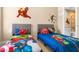 Fun ' bedroom with twin beds and Marvel theme at 7571 Sunny Dreams Ln, Kissimmee, FL 34747