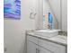 Modern bathroom with granite countertop and white cabinets at 7571 Sunny Dreams Ln, Kissimmee, FL 34747
