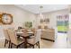 Bright dining area with table and chairs, near the living room at 7571 Sunny Dreams Ln, Kissimmee, FL 34747