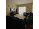 Bright living room featuring two comfy sofas and a large TV at 5518 Metrowest Blvd # 207, Orlando, FL 32811