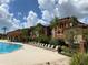 Expansive pool area with numerous lounge chairs at 5518 Metrowest Blvd # 207, Orlando, FL 32811