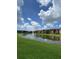 Community lake view with lush green space at 5518 Metrowest Blvd # 207, Orlando, FL 32811