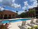 Community pool with plenty of lounge chairs for sunbathing at 5518 Metrowest Blvd # 207, Orlando, FL 32811