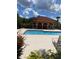 Inviting community pool with shaded seating area at 5518 Metrowest Blvd # 207, Orlando, FL 32811