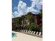 Building exterior with palm trees and lounge chairs at 5518 Metrowest Blvd # 207, Orlando, FL 32811