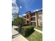 Three-story building with attractive facade and landscaping at 5518 Metrowest Blvd # 207, Orlando, FL 32811