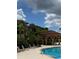 Relaxing pool area with a cabana and lounge chairs at 5518 Metrowest Blvd # 207, Orlando, FL 32811
