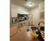 Well-equipped kitchen with white cabinets and modern appliances at 5518 Metrowest Blvd # 207, Orlando, FL 32811