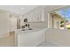 Updated kitchen with white cabinets and a curved breakfast bar at 1450 Cricket Ct, Longwood, FL 32750